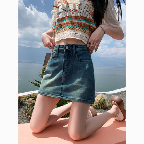 Leather-lined stretch denim short skirt for 2025, high-waisted, flattering for petite figures, showcasing a curvy silhouette.