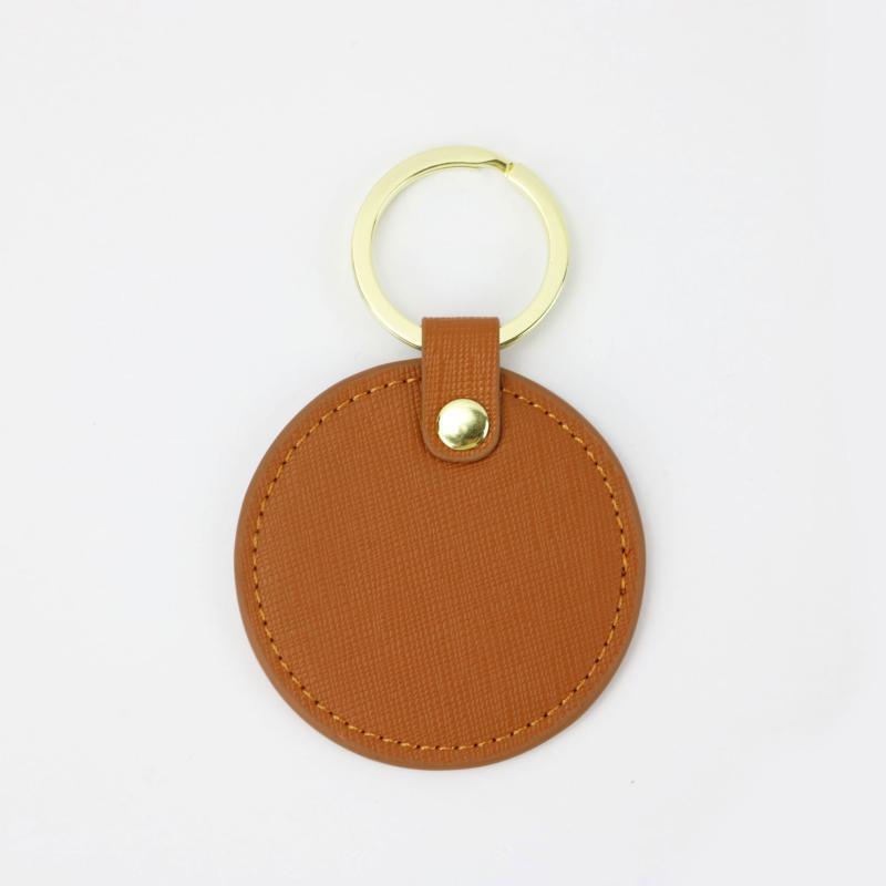 Llavero redondo de cuero genuino personalizado creativo simple colgante hombres y mujeres pequeño exquisito pequeño regalo al por mayor todo a juego