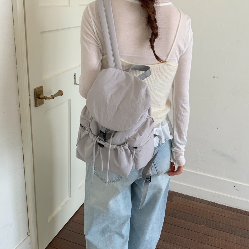 2026 más ocio simple de gran capacidad mochila de cuerda de extracción para estudiantes nueva mochila de bolsillo de mujer coreana de verano ligera