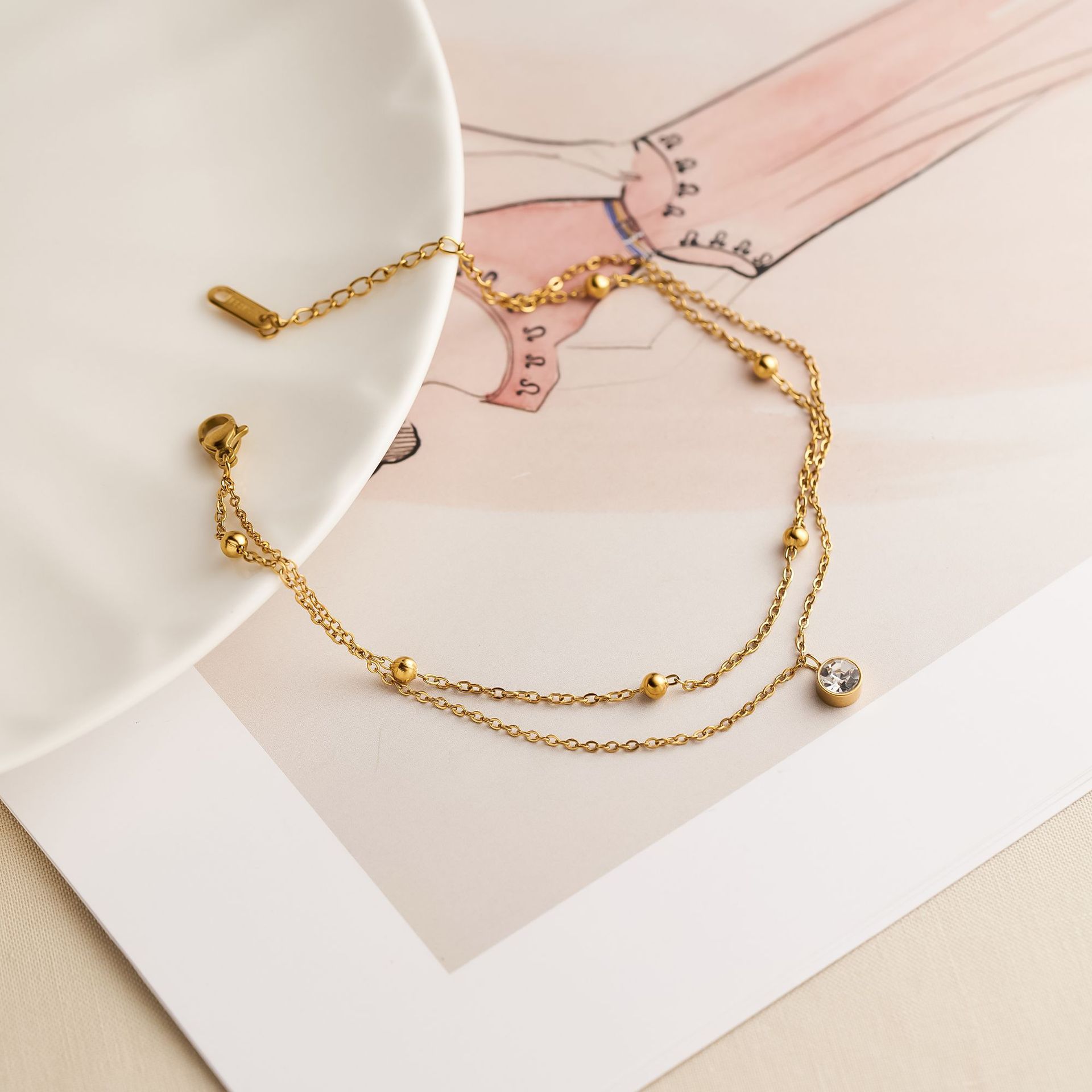 Verano de acero inoxidable de doble capa bola de oro pequeña tobillera individual femenina diamante de 18k oro ligero moda decoración de pies transfronteriza suministro directo de fábrica