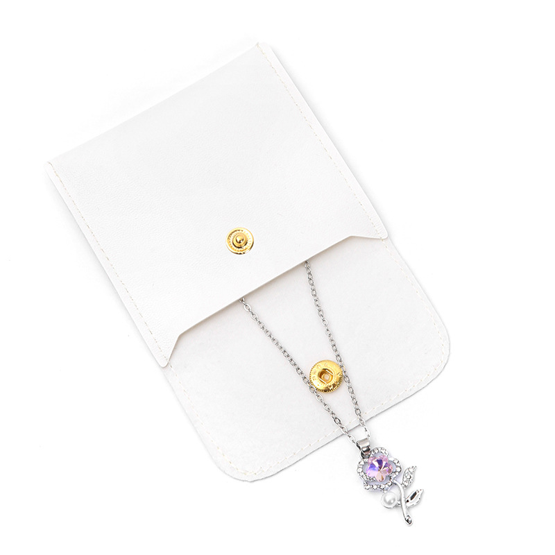 Bolsas de joyería de cuero PU nicho botón diseño collar anillo pulsera bolsa de almacenamiento antioxidante al por mayor
