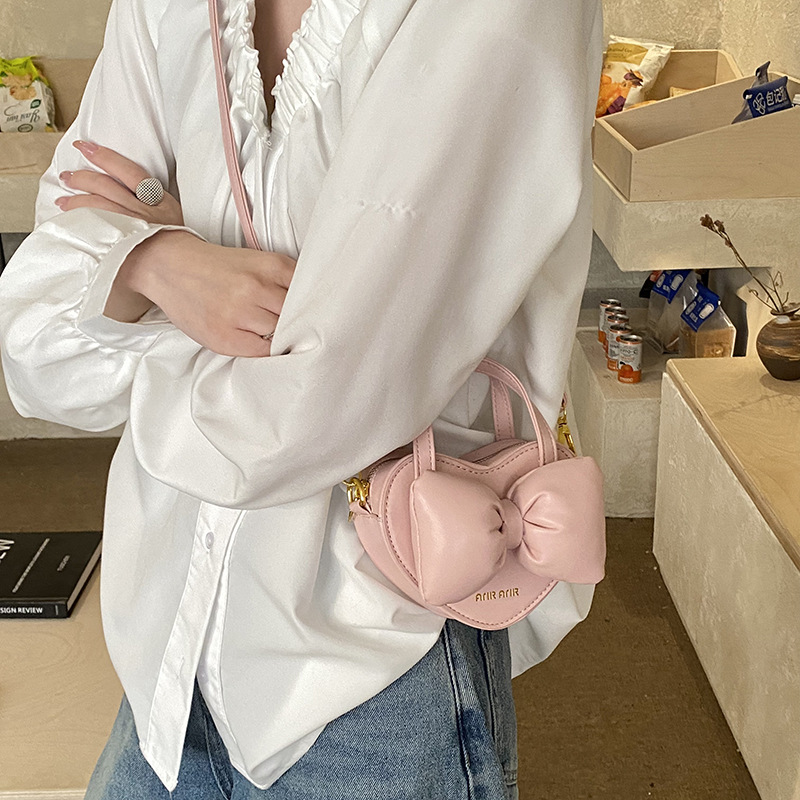 Mini lindos bolsos de mano en forma de corazón de melocotón, bolsos de hombro para bebés de color sólido, nuevos bolsos para niños transfronterizos