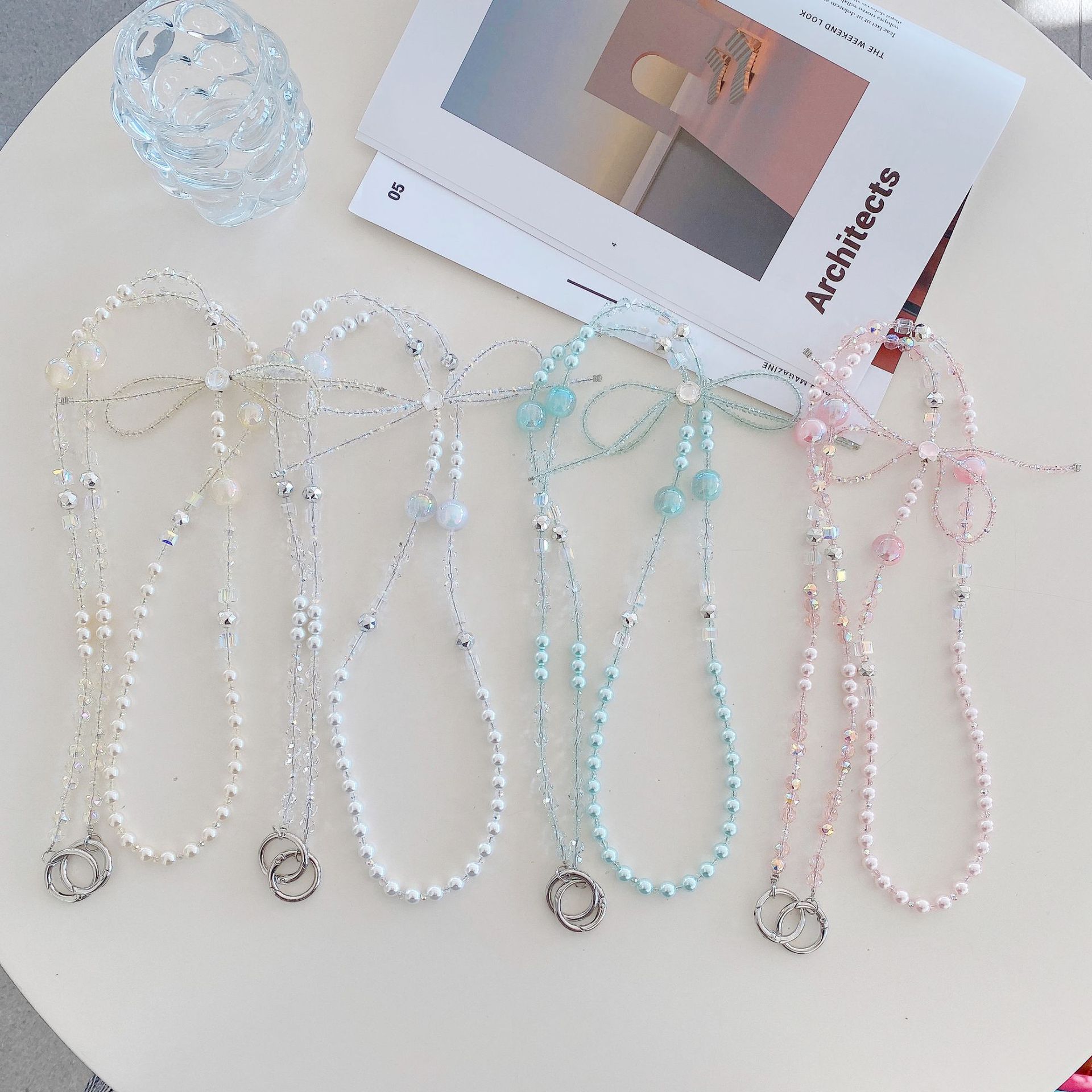 Boutique hecho a mano cadena colgante de alta gama arco fresco de cuatro colores cadena larga cordón de teléfono móvil de moda mensajero largo/colgante