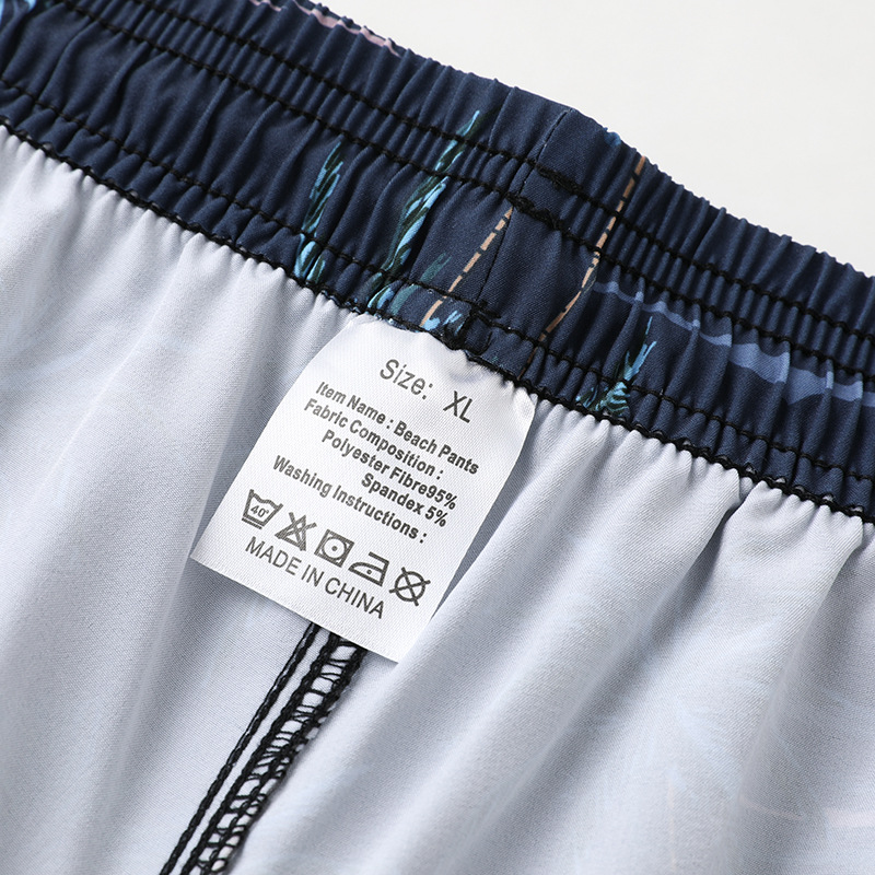 Spot al por mayor pantalones cortos de playa para hombres, pantalones de playa para parejas de vacaciones junto al mar, deportes para correr, pantalones cortos elásticos de secado rápido, de cinco puntos