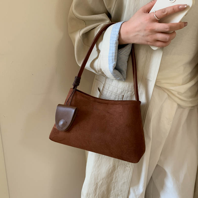 Niche de alta sensación de seda de abrigo bolso inferior para mujeres otoño / invierno 2025 nueva moda de moda universal bolso de mano de viaje