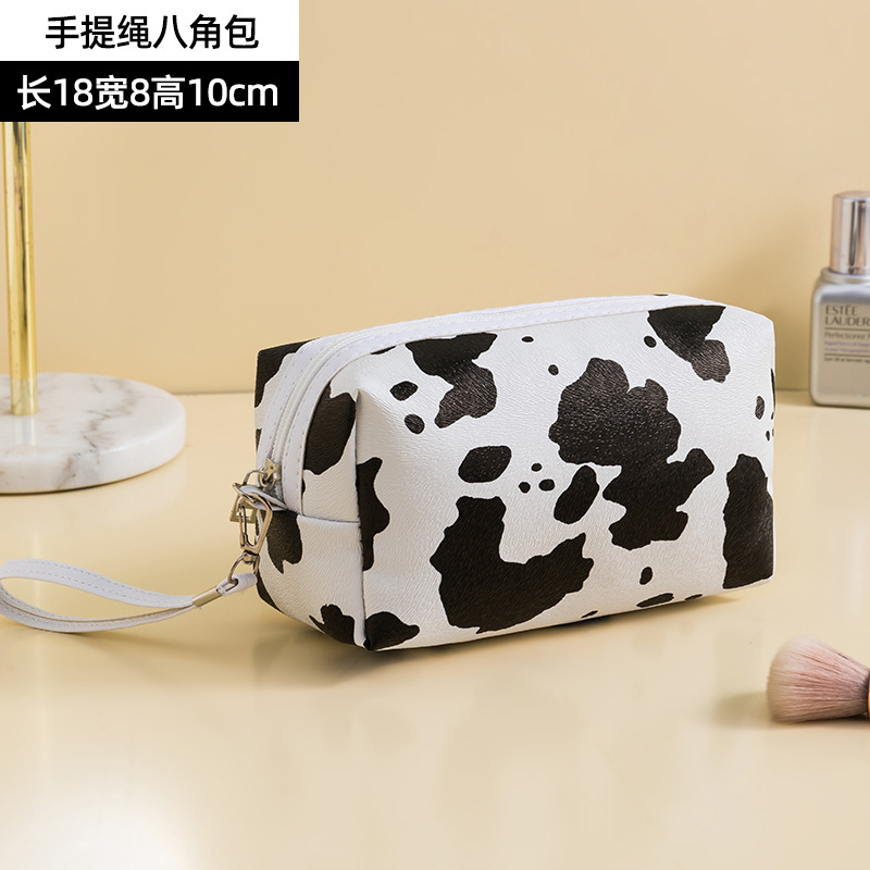Patrón de vaca PU bolsa de cosméticos impermeable de gran capacidad de alto aspecto portátil avanzado bolsa de almacenamiento cuidado de la piel bolsa de lavado al por mayor