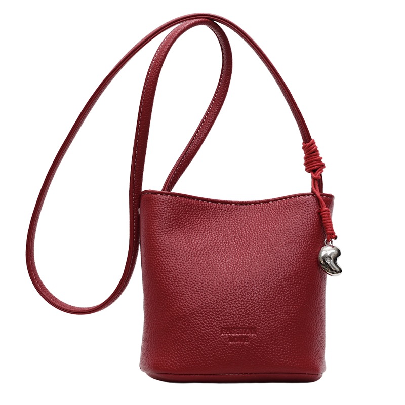 Bolsa de balde de moda de litchi para mujeres 2025 nuevo estilo de color sólido simple bolso de hombro mochila casual