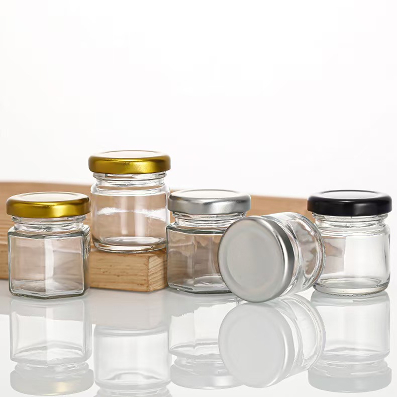 Inventario multi-especificaciones de latas de sellado transparentes de vidrio de seis bordes de miel botella de mermelada para probar mini pequeña botella de miel