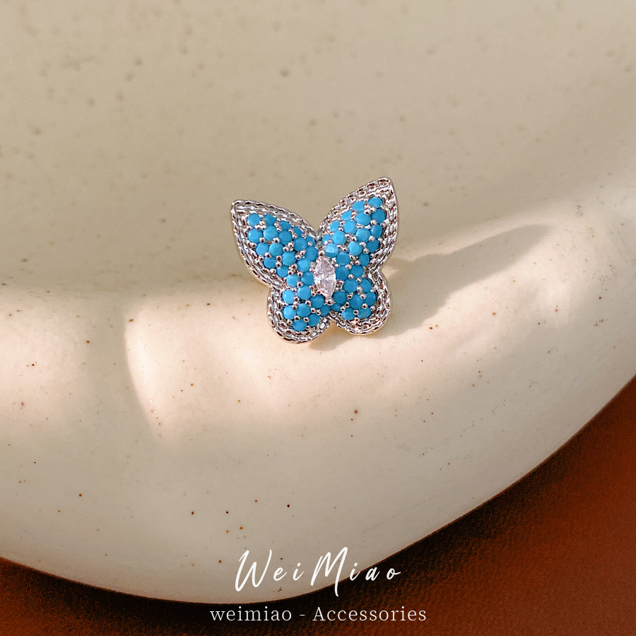 Piedra azul mariposa auriculares mujeres sin agujeros de orejas personalidad nicho pendientes de moda ligero lujo alta sensación auriculares al por mayor