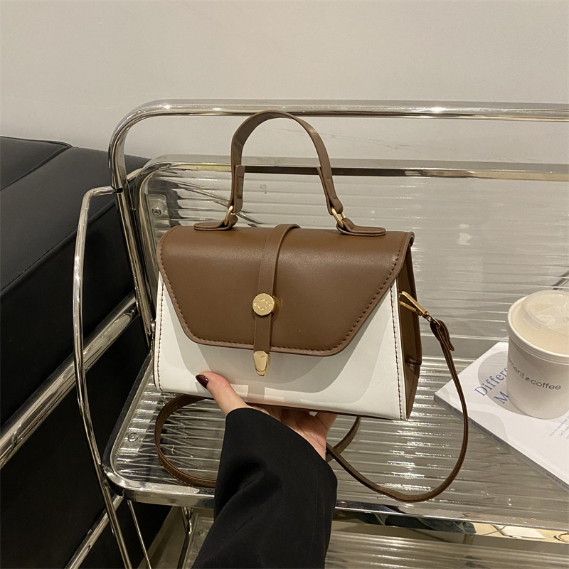 Bolsa de mano de textura de empalme retro para mujeres 2025 nuevo estilo simple y casual de moda extranjera bolso de hombro