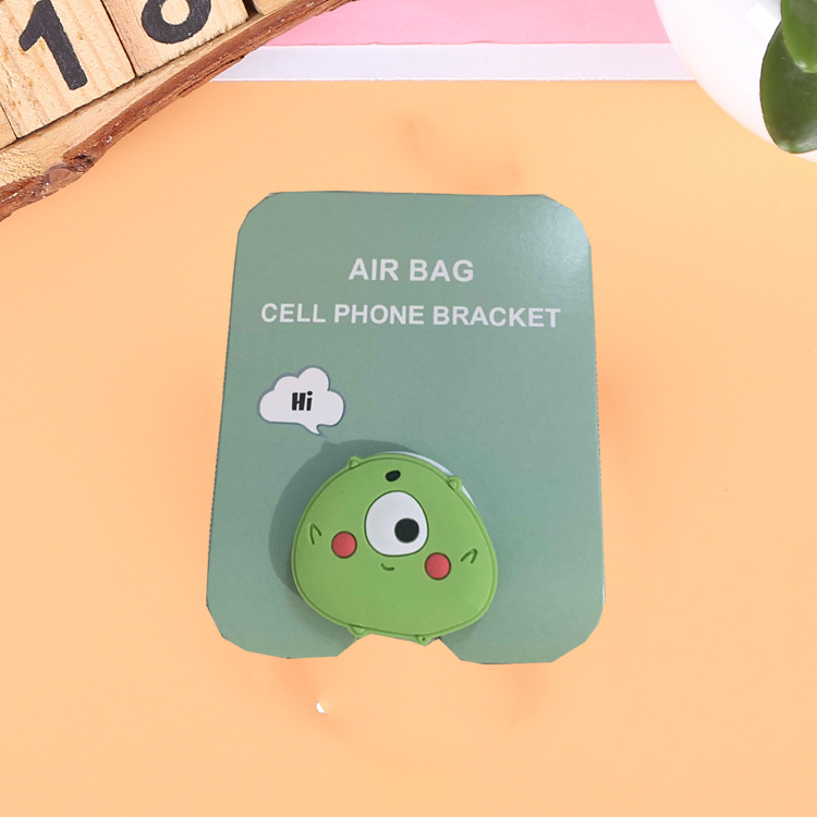 En stock al por mayor TikTok Cartoon creativo soporte de teléfono móvil puede soportar airbag soporte de teléfono móvil soporte de escritorio