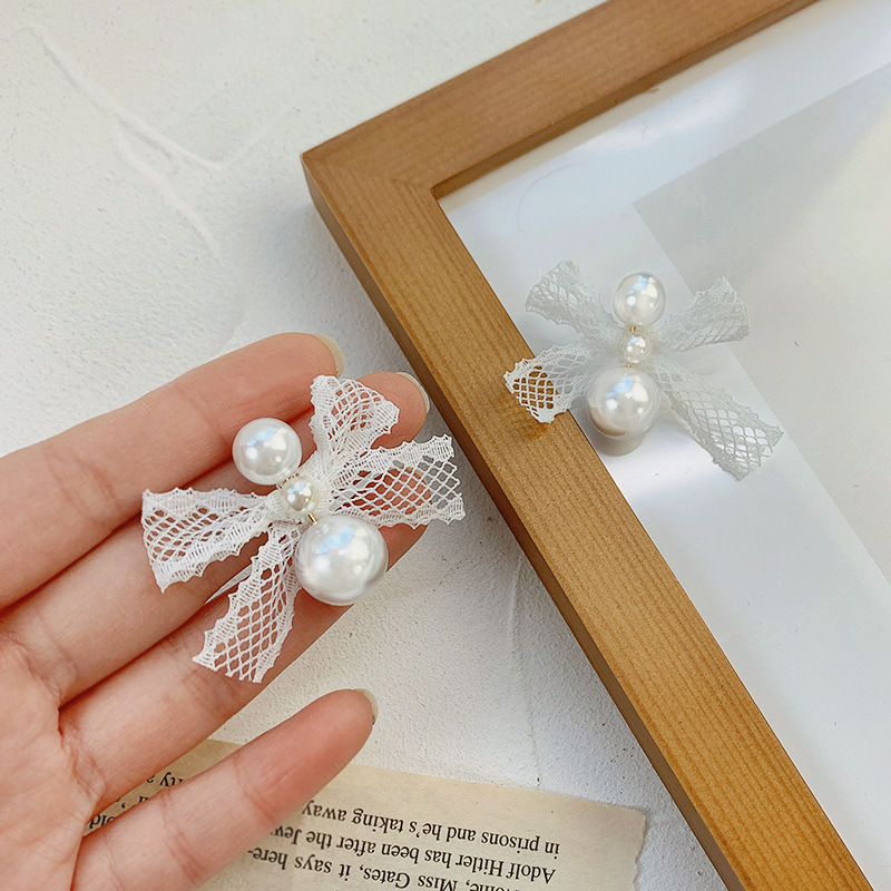 White elegant fresh cute hypoallergenic earrings with bow from pearl