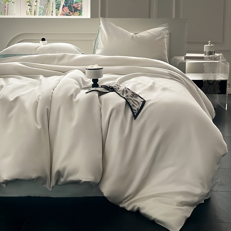 Juego de cama de verano de cuatro piezas de seda de hielo de lujo ligero 2025 nueva funda de edredón sábana sábana sábana ropa de cama desnuda sedosa