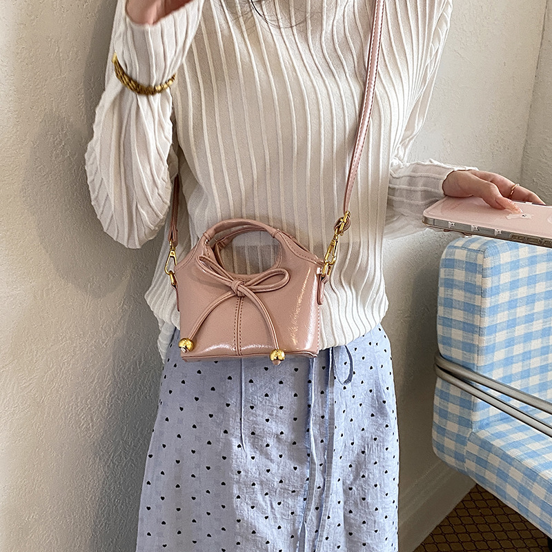 Bolsas infantiles transfronterizas de moda coreana de color sólido, bolsas de mano de chicas, mini bolsas de cestas de arco lindas