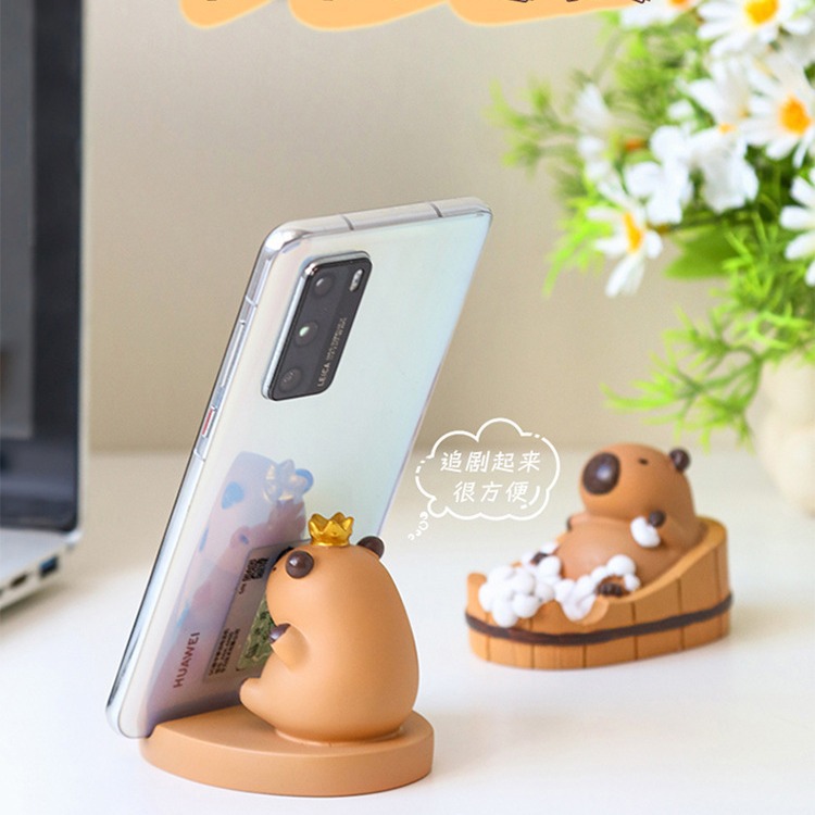 Dibujos animados linda celebridad de Internet Kapibala soporte para teléfono móvil decoración escritorio de oficina estación perezosa soporte plano artefacto