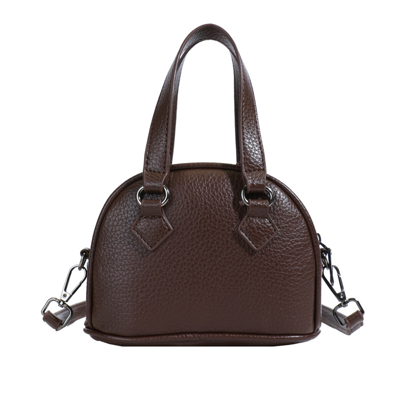 Moda coreana de color sólido bolso de hombro para hombres y mujeres, mini lindo bolso de concha de bebé 2025 nuevo bolso de mano para niños