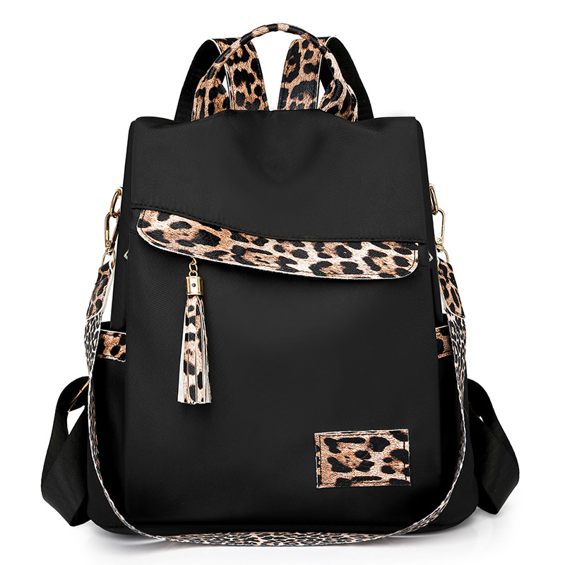 2024 nueva mochila antirrobo con estampado de leopardo de nylon para mujer, borla de moda, mochila de viaje de gran capacidad en contraste al por mayor