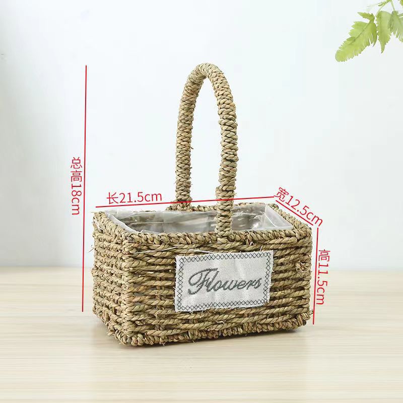 Fabricantes de cestas de flores ovales rectas de paja hechas a mano en stock al por mayor cestas de flores de paja portátiles decoración de viento pastoral