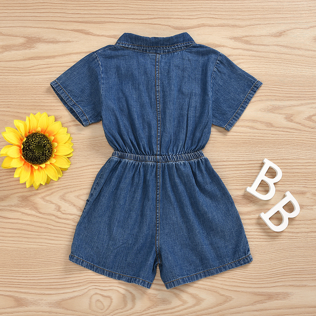 Girl playing in denim romper