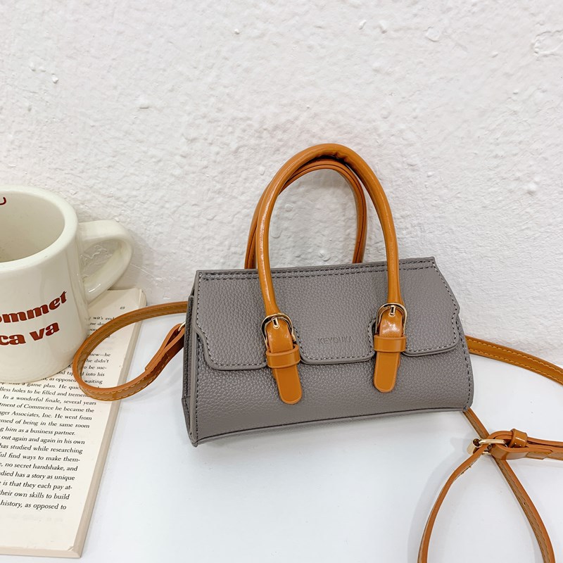 2025 nuevo bolso para niños de comercio exterior, bolso de niña popular de moda coreana, bolso de mensajero para bebé de color sólido de estilo extranjero