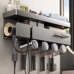 トイレの歯ブラシの歯のコップの棚は穴を開けないで壁掛け式の多機能の歯をかぶせます。