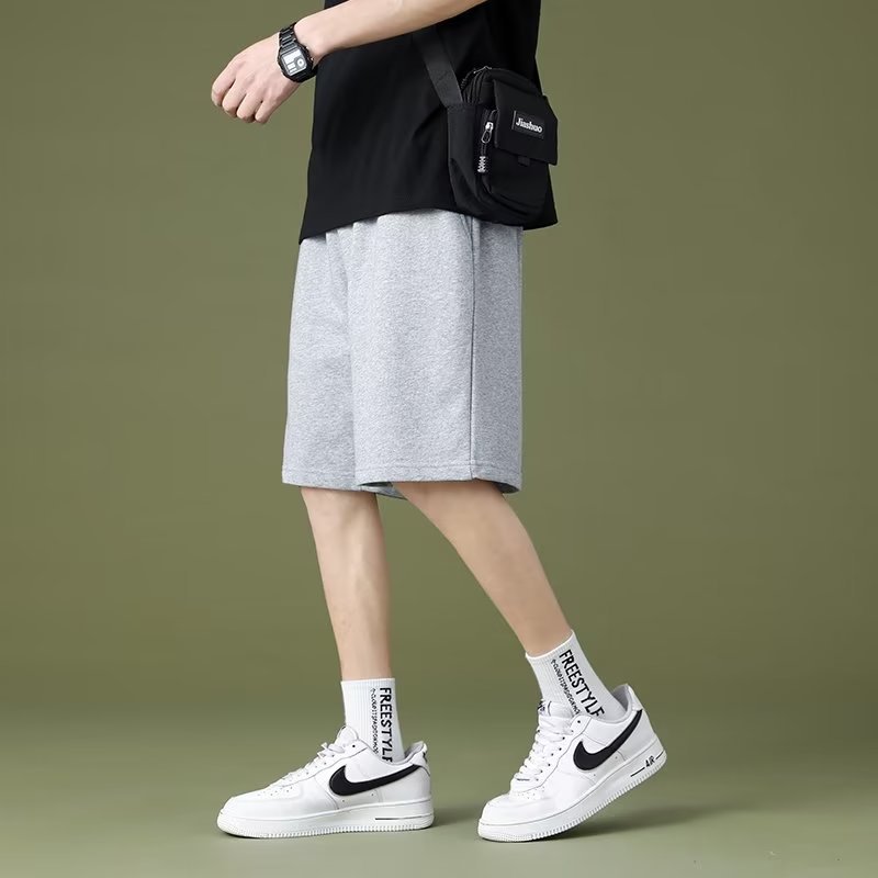 Pantalonos de cinco puntos de color sólido para parejas de moda masculinas delgados cintura elástica de verano universal simple adelgazamiento deportivo ocio