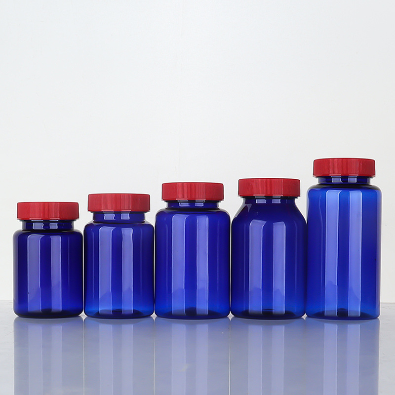 Botella de plástico azul 80–150 ml con tapa estriada, envase para suplementos o cápsulas.