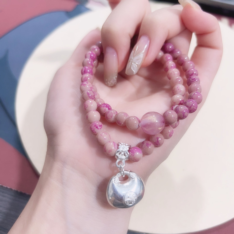 Bracciale con perline rosa e ciondolo portafortuna donna_voghion.com