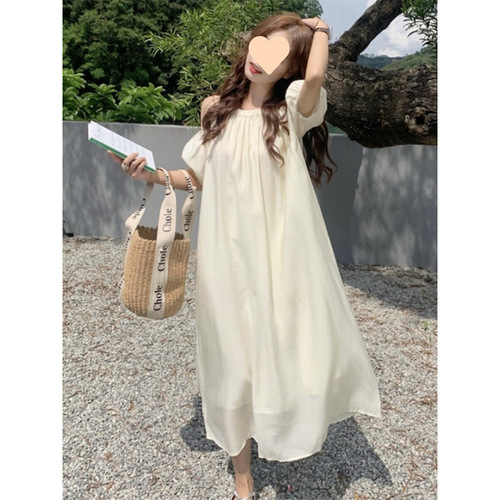 Elevated maternity dress for summer: chic, laid-back design with delicate cutouts and an off-shoulder neckline—perfect for a stylish, mid-length summer look.