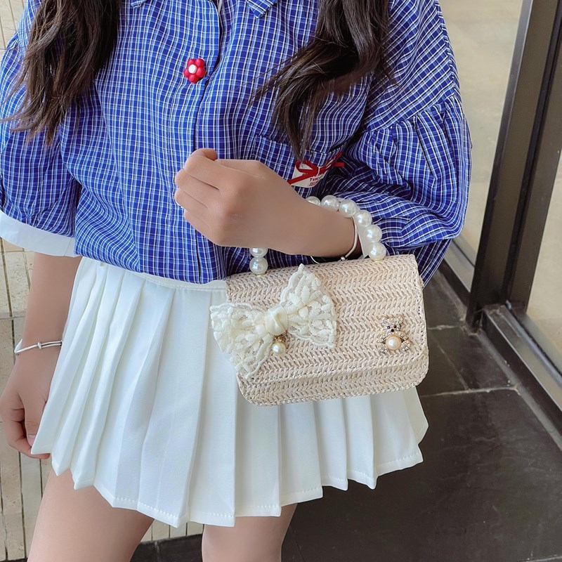 Verano nuevo arco de paja bolso de perla bolso de moda para niños bolso de princesa de jardín de infantes