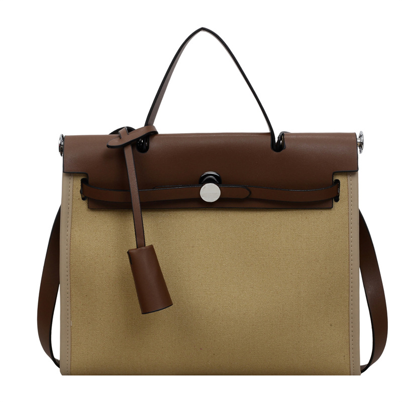 Nicho de moda portátil Kelly bolso mujer 2026 nuevo cross-border lienzo empalme color contraste viaje mochila de hombro