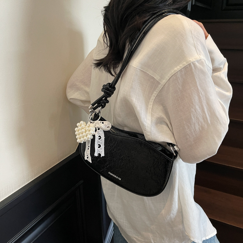 Bolsos pequeños de alta calidad 2025 verano nuevo estilo bolso femenino diseño de nicho bolso de hombro moda patrón de agarre de mano bolso de mensajero