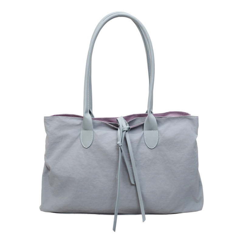 2026 nuevo paquete de moda de tela de alta capacidad, bolso de hombro de alta calidad, bolso de bolsillo pequeño y multifuncional.