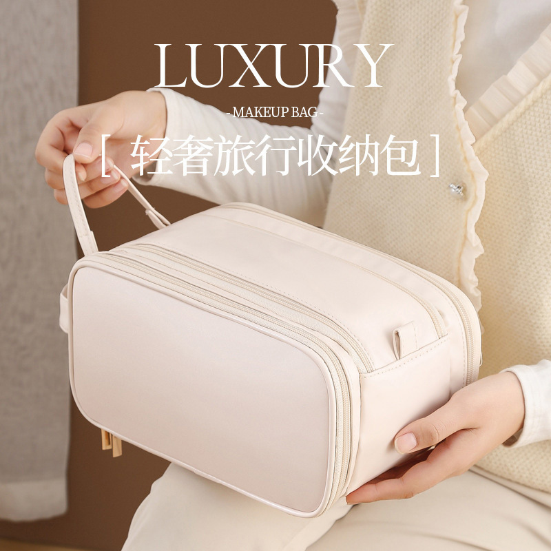 2025 nueva bolsa de maquillaje portátil de almacenamiento de gran capacidad de viaje de mujeres bolsa de lavado de lavado cepillo de maquillaje bolsa de escritorio