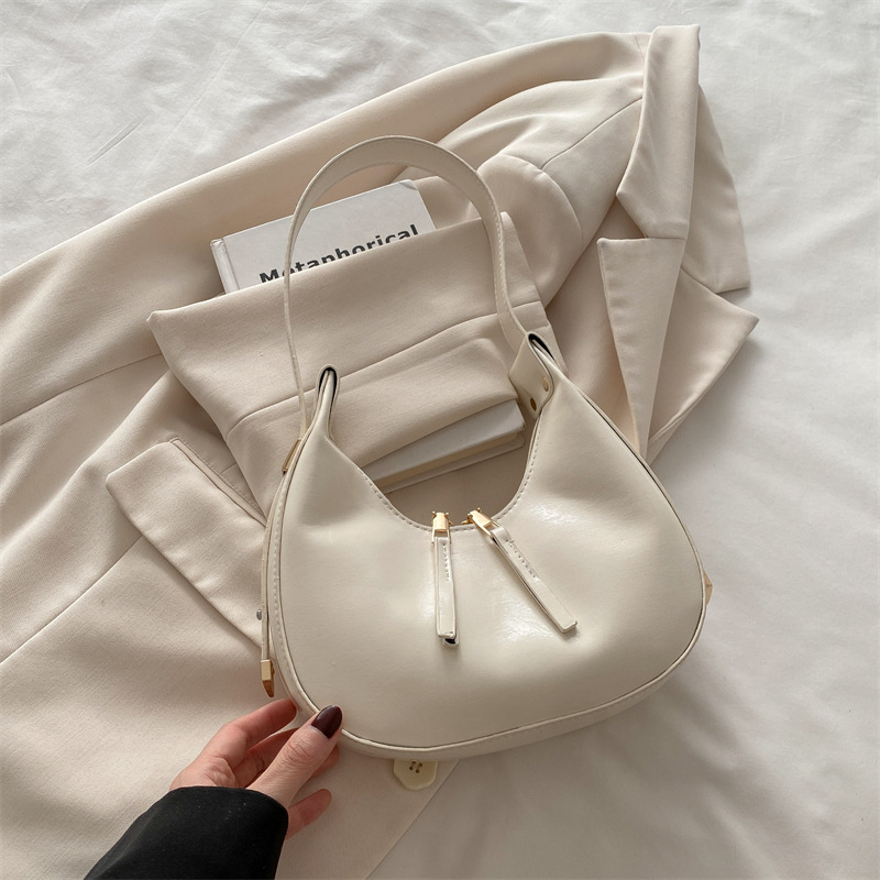 Estilo coreano ins 2025 primavera y verano nuevo diseño de nicho celebridades de Internet damas con un solo hombro y axilas albóndigas paquete de medio mes