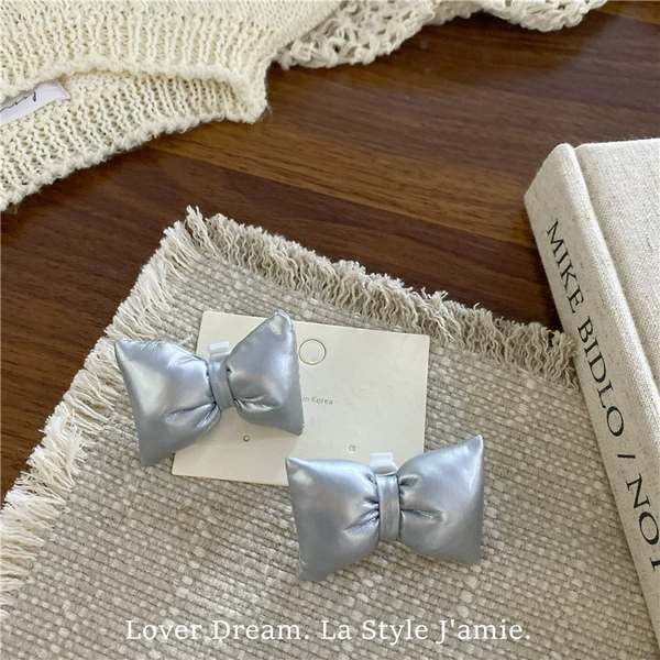 Pair of silver faux leather bow shoe buckles