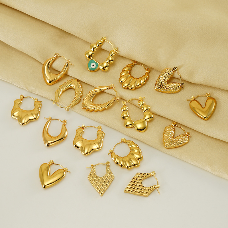 Cross-border europeo y americano de alta calidad de acero inoxidable 18K chapado en oro retro diseño hueco pendientes de ojo verde pendientes