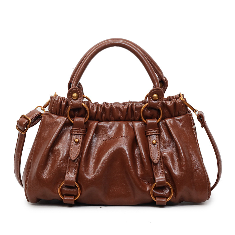 Retro bolso de mano plegable mujer 2025 otoño y invierno nuevo nicho de diseño bolso de cubo de viaje mochila de hombro