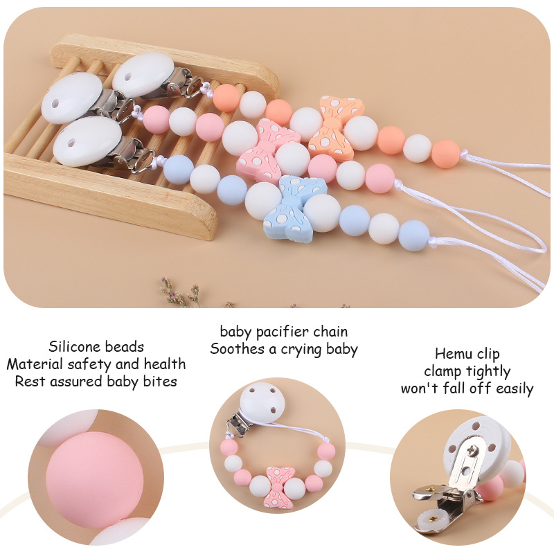 Suministros para bebés hemu clip de chupete calmante bebé de dibujos animados arco mordedura pegamento cadena de chupete cadena anti-caída nueva