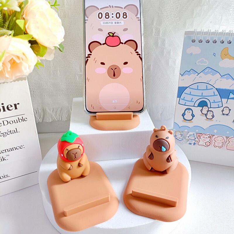 創意カピバラの子供の携帯電話のスタンドは携帯電話を並べてタブレットのデスクトップの棚に座って携帯します。|undefined