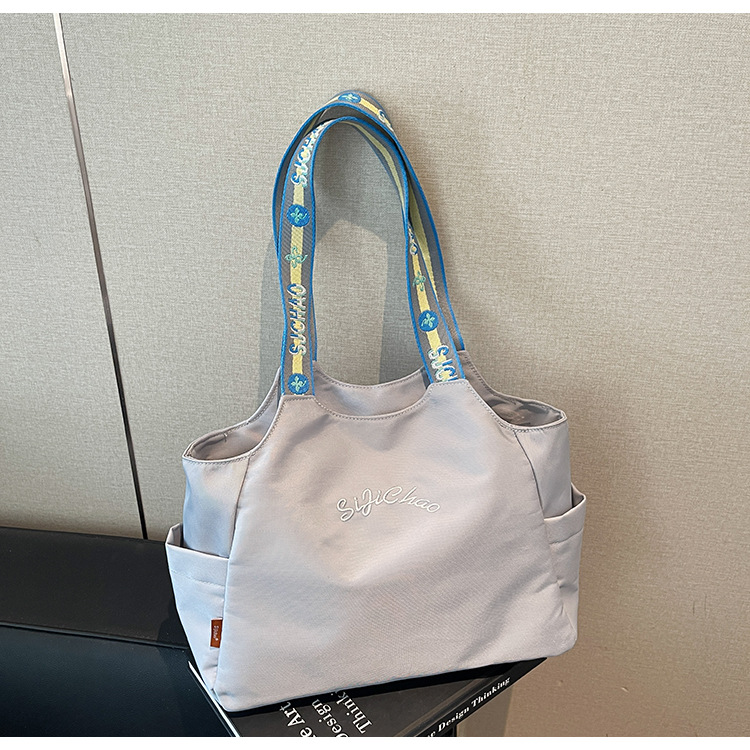 Bolsas de lona de moda de gran capacidad para mujeres 2026 nueva textura bordada letras bolsas de hombro de viaje simple bolsas de mano