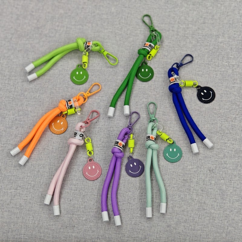 Sonriente cuerda de trenzado llaves de coche bolsos colgantes bolsos accesorios de ropa en caso de teléfono móvil cuerda de color