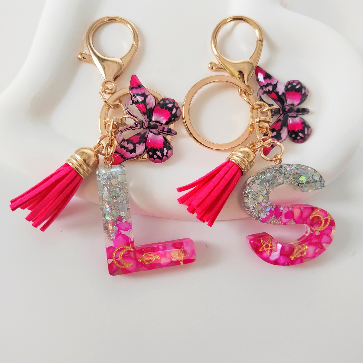 Inventario transfronterizo nueva resina bicolor mariposa borda llavero colgante estrella luna accesorios de joyas