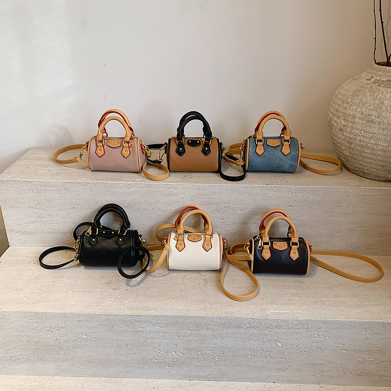 Bolso de niña coreana moda contraste color estilo occidental mini bolsa de tubo de bebé 2025 nuevo bolso de almohada para niños