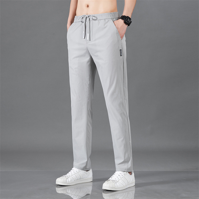 Pantalones largos delgados de verano para hombres tendencia universal de hielo rápido secado deportivo relajado grande pantalones casuales al por mayor