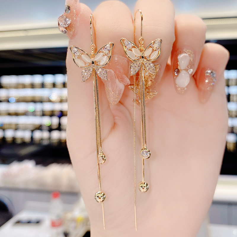 S925 aguja de plata Corea del Sur Dongdaemun elegante micro con incrustaciones de circón mariposa borla anti-perdida hilo de oreja moda pendientes del todo-fósforo para las mujeres
