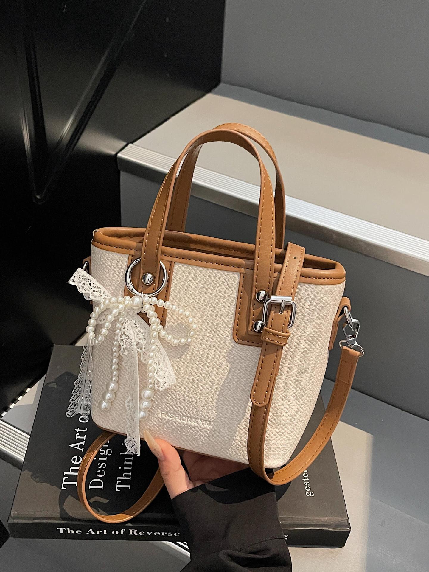 Bolso de cubo de mano de estilo occidental de moda para mujer 2025 nuevo bolso de hombro de todo fósforo de color de contraste bolso de mensajero de viaje de textura de moda