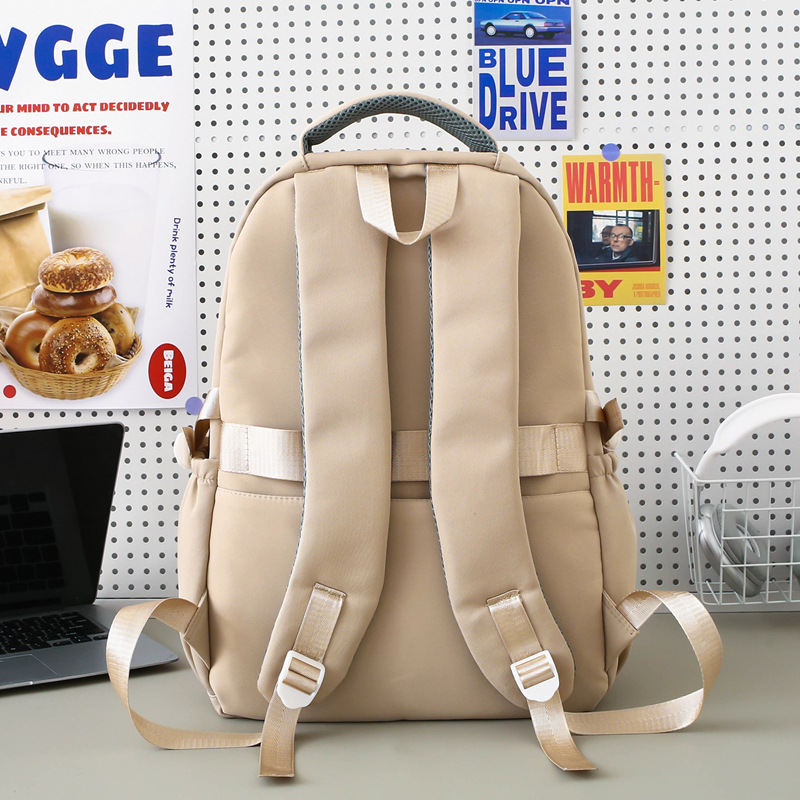 Al por mayor nueva mochila coreana universitaria simple mochila de alto valor de la cara, mochila de niñas de gran capacidad para estudiantes de secundaria