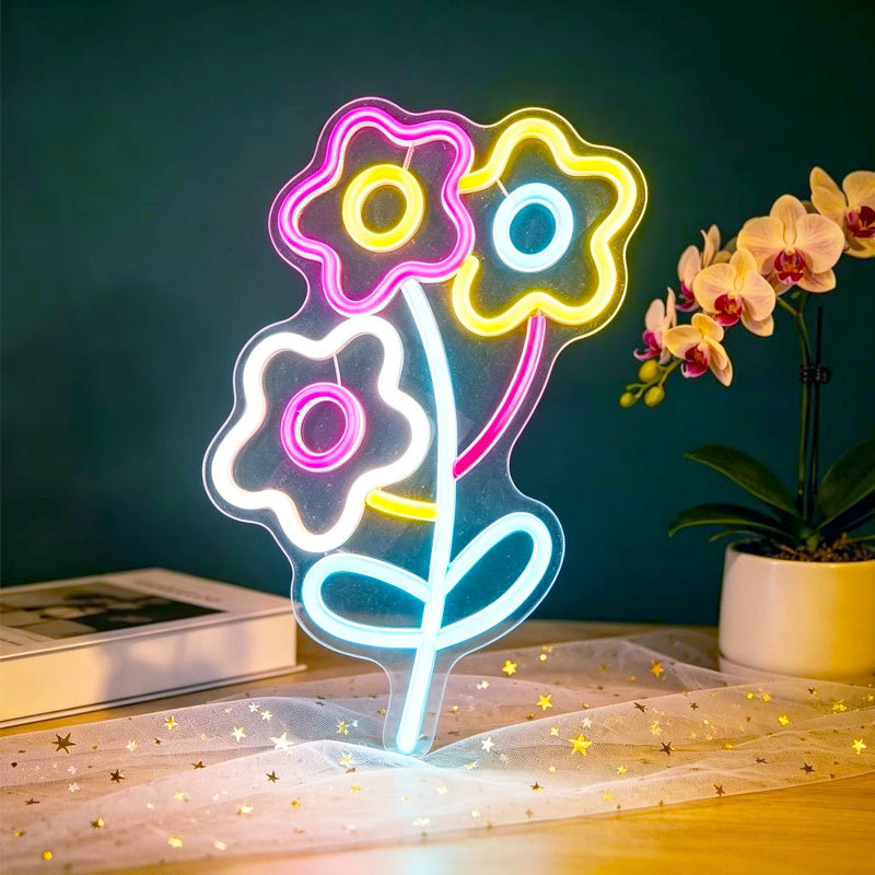 Three small flower-shaped LED neon lights, with a transparent back panel and a fresh flower outline, USB powered.