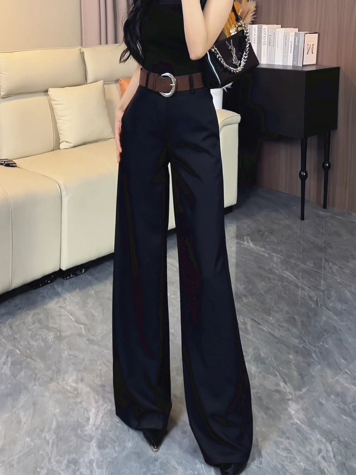 Black, elegant, and slightly flared suit pants for women, featuring a high waist, wide legs, and a floor-length design, perfect for autumn